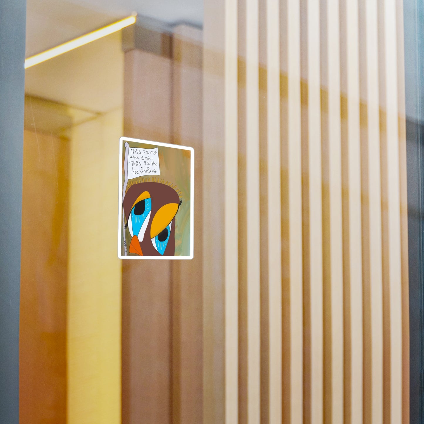 The Printify Vinyl Decal - Sobriety Gifts, featuring the handwritten phrase “This is Not The End,” is displayed on a clear glass wall with wooden panels in the background.