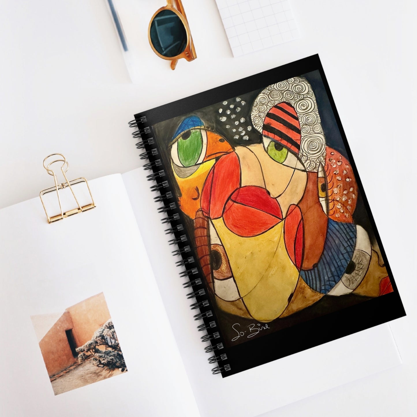 The Printify Spiral Notebook - Ruled Line ‘It’s a we thing. In recovery we don’t have to do this alone’ Journal features colorful abstract face art—ideal for gratitude journaling or marking sobriety milestones.