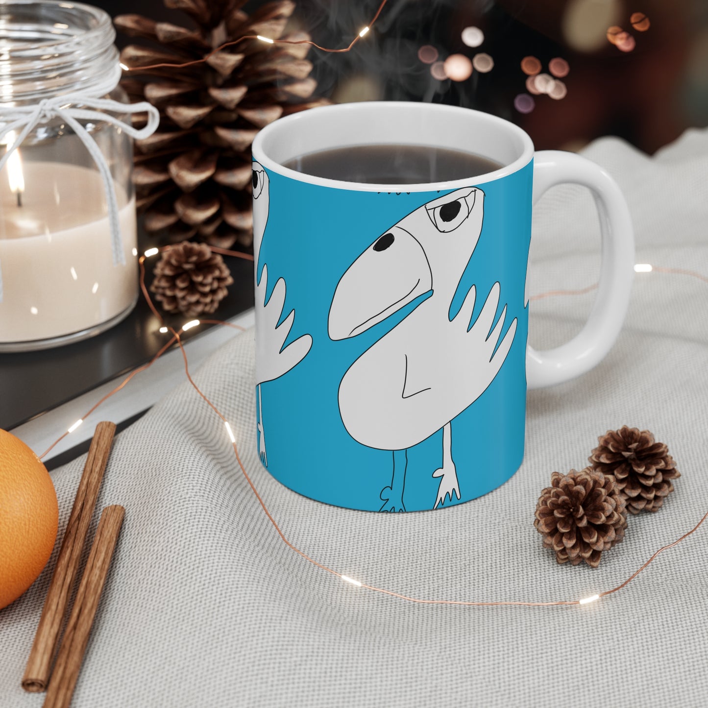 The 1:1 - Mug - 11oz by Printify features a quirky bird illustration on a blue background. With coffee inside and cozy accents like pinecones and cinnamon sticks, it’s an ideal sobriety gift for relaxing moments.
