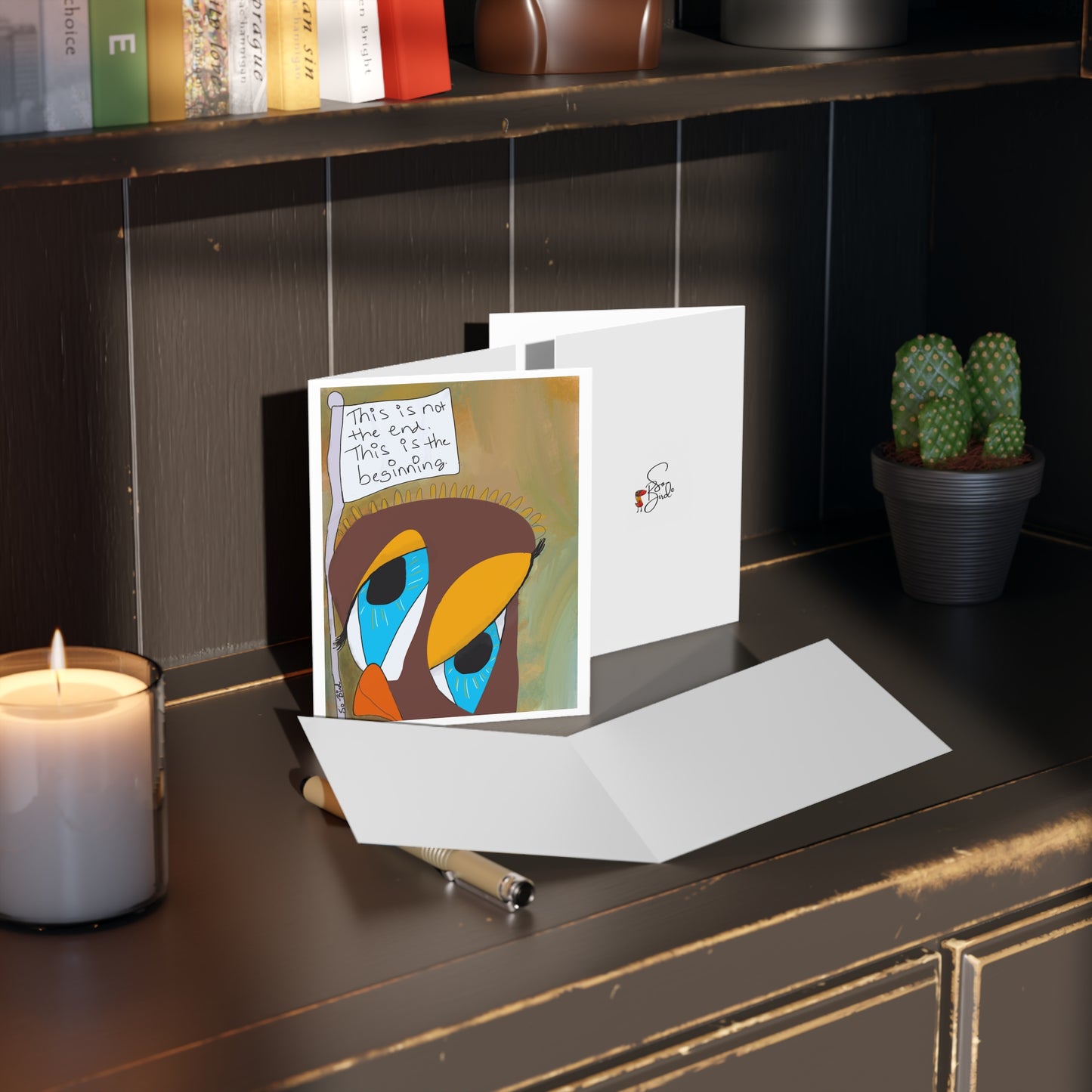 Printify’s Greeting Cards -Blank inside- Surrender, Step One, This is Not the End, This is the Beginning (Set of 24) features uplifting designs—perfect for inspiring new beginnings and positivity. Candle, pen, card, and small potted cactus not included.