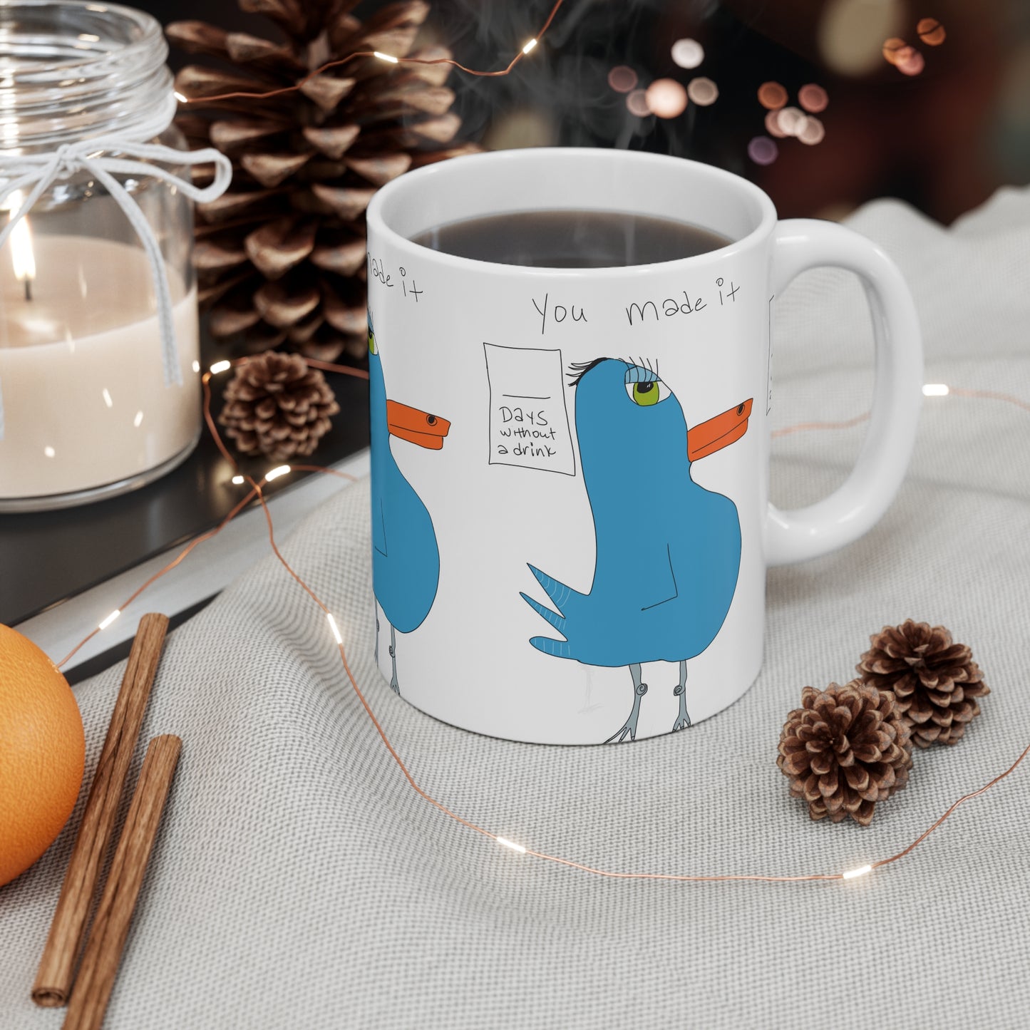 The Recovery Celebration Mug - 11oz by Printify features cartoon blue birds with “You made it” and “Days without a drink.” Filled with coffee, it’s a perfect sober lifestyle gift, adding cheer to any cozy table.