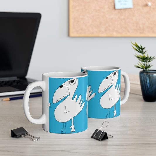 Two Printify 1:1 Mug - 11oz ceramic mugs with a cartoon white bird on blue sit on a desk, making them ideal as sobriety or recovery gifts. Binder clips, a laptop, potted plant, and corkboard complete the scene.
