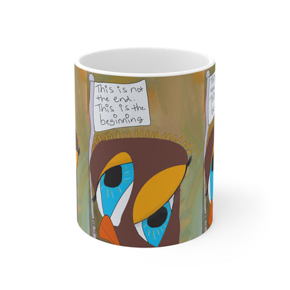 The Printify "This Is Not The End Mug" (11oz) features abstract, colorful bird faces with large blue eyes. One bird holds a sign reading, "This is not the end. This is the beginning." Earth tones make it a unique recovery gift.