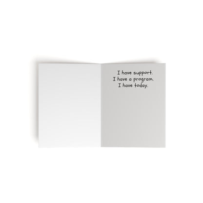 The Printify Greeting Cards Set - Powerless, not helpless features an inspirational message: "I have support. I have a program. I have today." The left page is blank, perfect for sharing words of encouragement with someone special. Available in 8, 16, or 24 pcs.