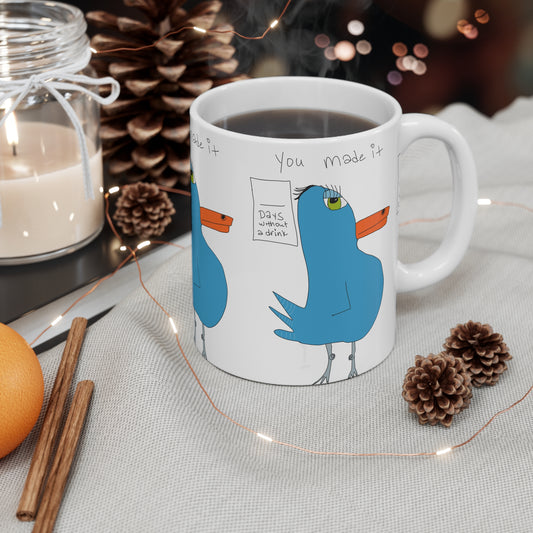 The Recovery Celebration Mug - 11oz by Printify features cartoon blue birds with “You made it” and “Days without a drink.” Filled with coffee, it’s a perfect sober lifestyle gift, adding cheer to any cozy table.